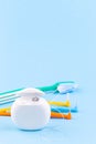 Dental floss, toothbrush and interdental brush angles on blue background, vertical, copy space Royalty Free Stock Photo