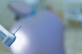 Dental handpiece with diamond bur close-up against the background of the dental chair