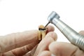 dental handpiece drills a tooth isolated on a white background, the treatment of carious tooth, the training