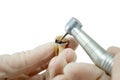 Dental handpiece drills a tooth isolated on a white background, the treatment of carious tooth, the training