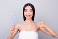 Dental health concept. Gorgeous asian girl in white towel is smiling, on light background, she has a beaming smile Royalty Free Stock Photo