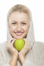 Dental Health Concept: Happy Smiling Caucasian Woman Holding Green Apple in Front of Her Mouth Royalty Free Stock Photo