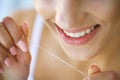 Dental Health. Woman With Beautiful Smile Flossing Healthy Teeth Royalty Free Stock Photo