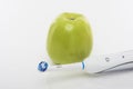 Dental Hygien Concept: Green apple Together With Electric Toothbrush Royalty Free Stock Photo