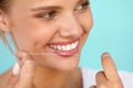 Dental Hygiene. Beautiful Woman Flossing Healthy White Teeth