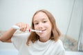 Dental hygiene. Happy little blonde girl brushing her teeth. Healthy concept Royalty Free Stock Photo