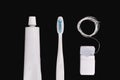 Dental hygiene objects: toothbrush, toothpaste and floss.