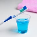 Dental hygiene. Toothbrush, mouthwash, pink towel Royalty Free Stock Photo