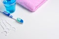 Dental hygiene. Toothbrush, mouthwash, pink towel, dental floss Royalty Free Stock Photo