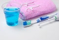 Dental hygiene. Toothbrush, mouthwash, pink towel, dental floss Royalty Free Stock Photo