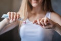 Dental hygiene. Unrecognizable young girl applying paste on her toothbrush in bathroom, close up Royalty Free Stock Photo