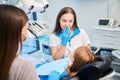 Dental hygienist and assistant are conducting appointment in dental office