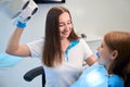 Dental hygienist begins to examine a young patient