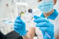 Dental hygienist checking sterility and cleansity of dental tools