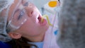 Dental hygienist makes ultrasonic cleaning dry teeth to woman, closeup view.