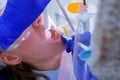 Dental hygienist makes ultrasonic cleaning dry teeth to woman, closeup view.