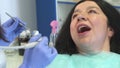 Dental hygienist provides root planing for patient