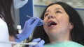 Dental hygienist provides root planing for patient