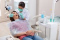 Dental hygienist putting a mirror into a patients mouth