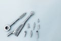 Dental implantation tools: reversible key, torque wrench on a blue background