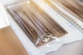 Dental instruments in sterile sealed packaging with blurry background