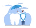 Dental insurance concept, dentist covers big white tooth from trouble with an umbrella. Tooth protection. Healthcare and Royalty Free Stock Photo