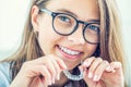 Dental invisible braces or silicone trainer in the hands of a young smiling girl. Orthodontic concept - Invisalign Royalty Free Stock Photo