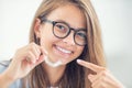 Dental invisible braces or silicone trainer in the hands of a young smiling girl. Orthodontic concept - Invisalign Royalty Free Stock Photo