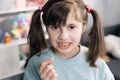 Dental medicine or temporary teeth health care concept. Portrait of a baby girl with a toothless smile. Shows a ripped Royalty Free Stock Photo