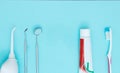 Dental Metal medical dentistry equipment tools, toothbrush and toothpaste dental care on blue background Royalty Free Stock Photo