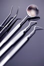 Dental mirror and other tools on blue shiny background Royalty Free Stock Photo