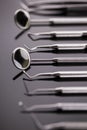 Dental mirror and other tools on shiny table Royalty Free Stock Photo