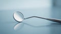 A dental mirror on a smooth surface symbolizes progress in medical devices and medicines Royalty Free Stock Photo