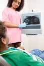 Dental nurse showing patient x ray