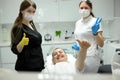 dental office satisfied patient showing thumbs up big class she liked service new technology doctor and assistant