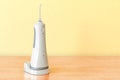 Dental oral irrigator on the wooden table. 3D rendering Royalty Free Stock Photo