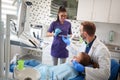 Dental ordination with patient in dental chair with doctor and a Royalty Free Stock Photo