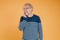 Dental pain. Portrait senior old man sad hand touching cheek suffering from toothache studio shot isolated on yellow background, Royalty Free Stock Photo