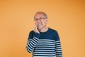 Dental pain. Portrait senior old man sad hand touching cheek suffering from toothache studio shot isolated on yellow background, Royalty Free Stock Photo