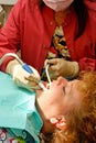 Dental patient getting mouth suctioned Royalty Free Stock Photo
