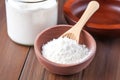 dental powder in a container with a tiny wooden spoon