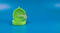 Dental retainer with green colored case, blue background Royalty Free Stock Photo
