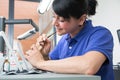 Technician in a dental laboratory applying ceramics to a prosthesis Royalty Free Stock Photo