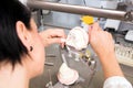 A dental technician working on a mold in a laboratory