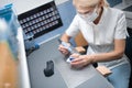 Dental technician doing denture polishing on her table.