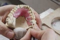 Dental technician doing partial dentures of acrylic resins.