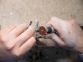 Dental technician grinding metal crown with rotary tool, manual dental prosthetics process, precision dentistry work and Royalty Free Stock Photo