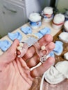 Removable denture in the hand of a dental technician. Blurred background. Orthopedic dentistry.