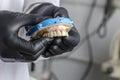 Dental technician holding a monolithic zirconia
