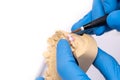 Dental technician using a brush with ceramic dental implants in his laboratory Royalty Free Stock Photo